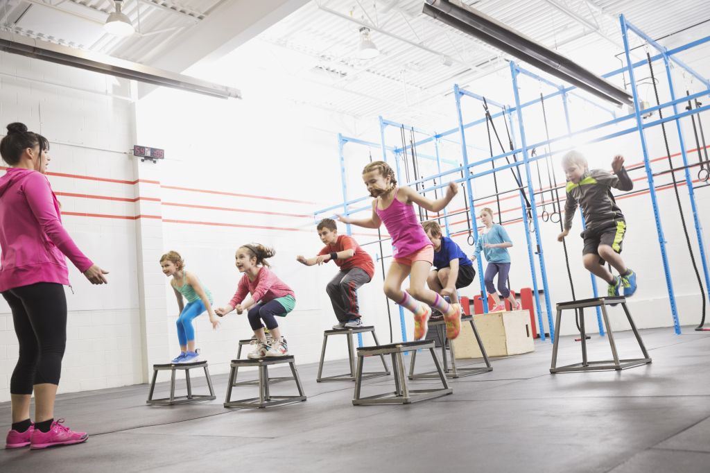 Children doing box jumps at gym