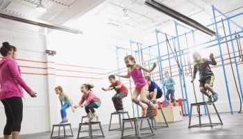 Children doing box jumps at gym