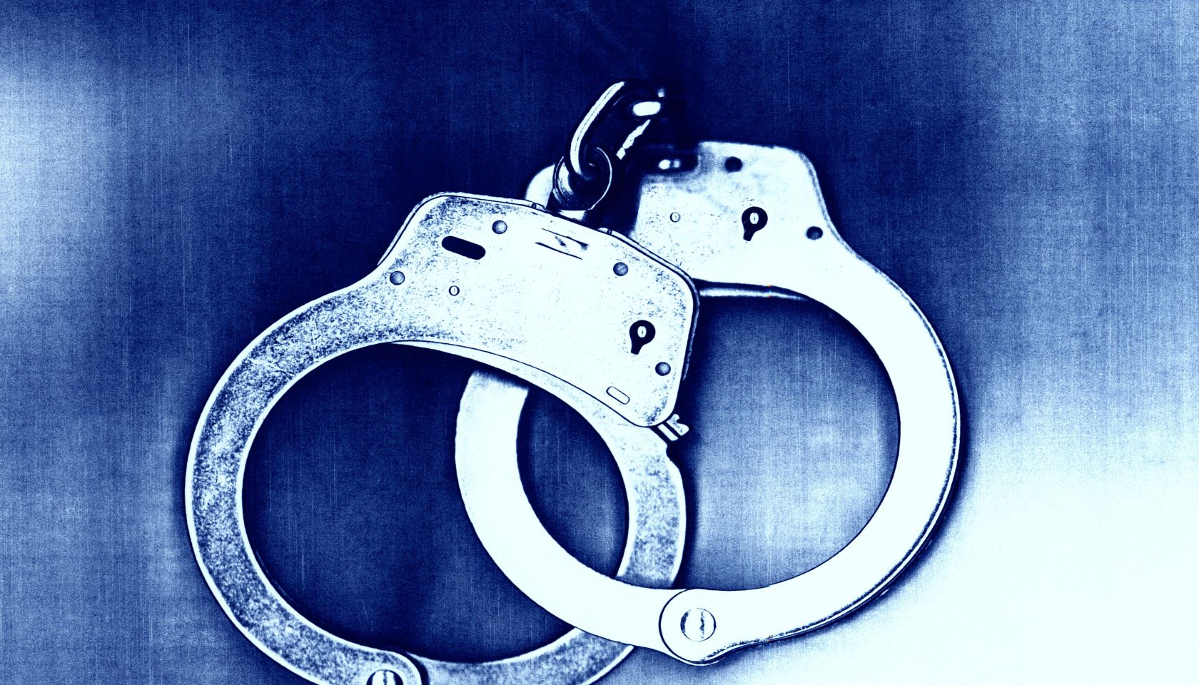 Blue tone of locked handcuffs.