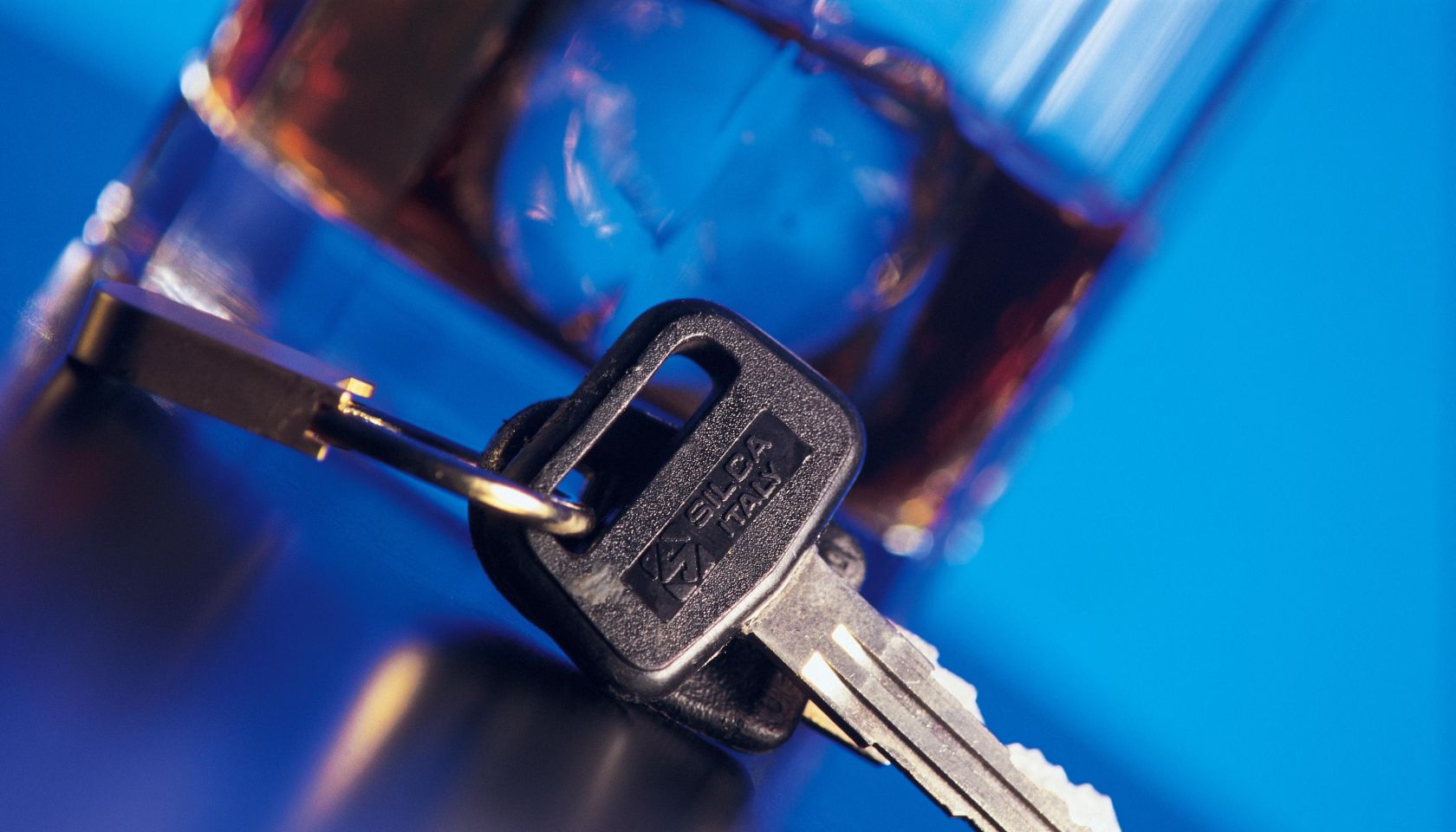 Car keys next to alcoholic beverage