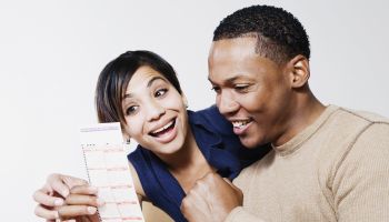 Excited couple looking at lottery ticket