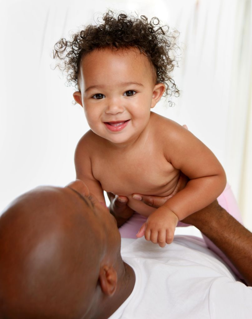 Baby plays with her dad.