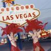 Two Chorus Girls in Full Stage Costume Posing by a Road Sign in Las Vegas