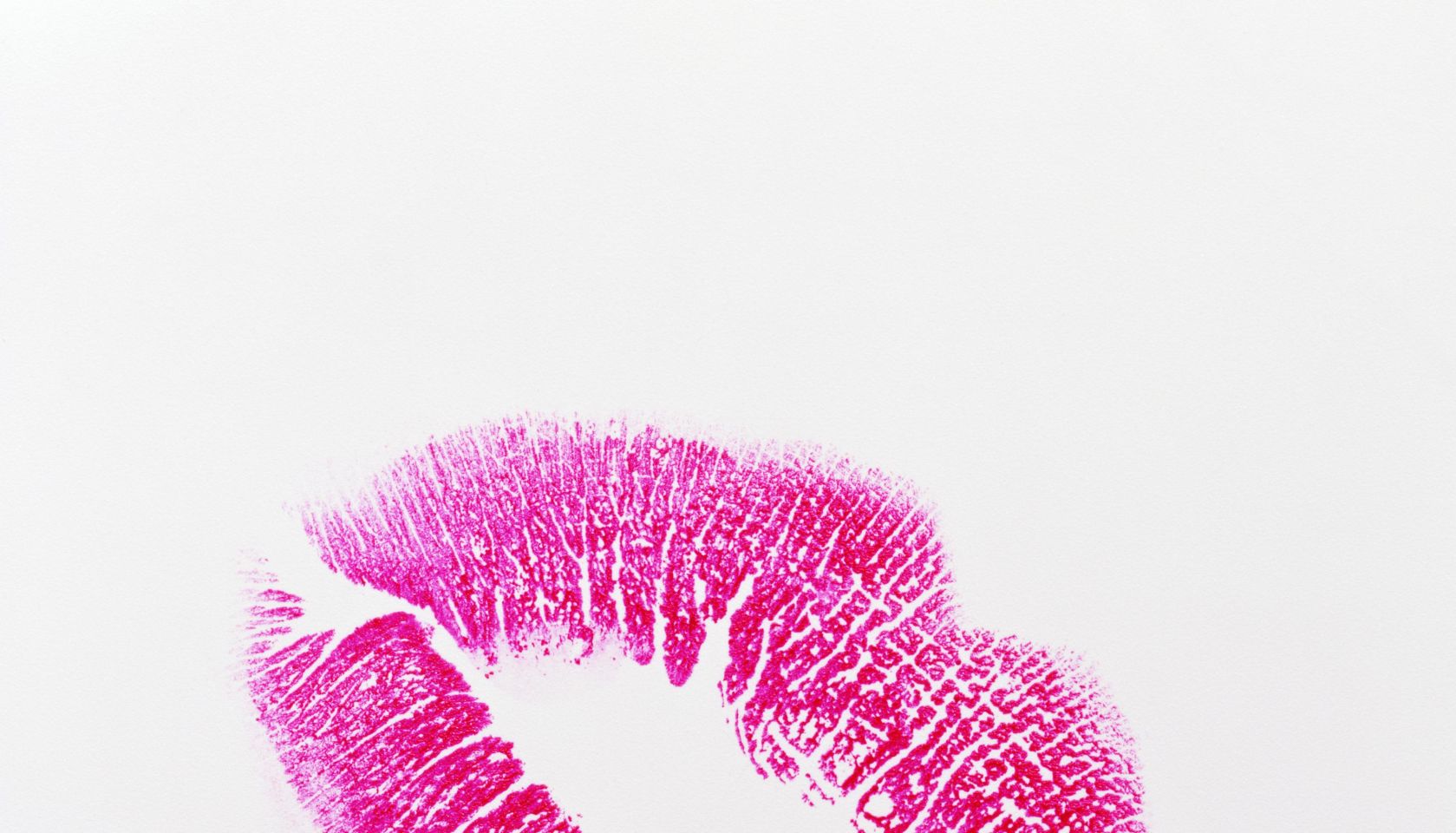 Lipstick kiss on white background, close-up