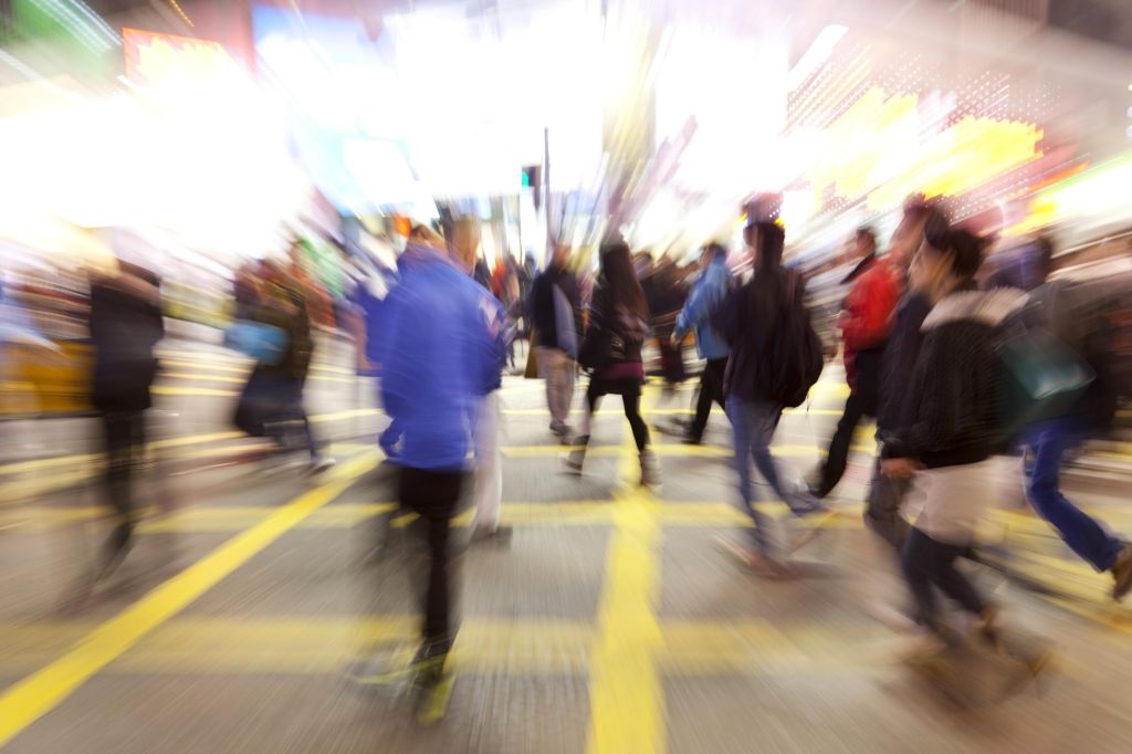 Young people crossing street, motion blur