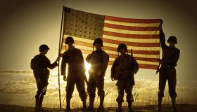 WWII Soldiers Standing In A Flag Draped Sunset - SIlhouette