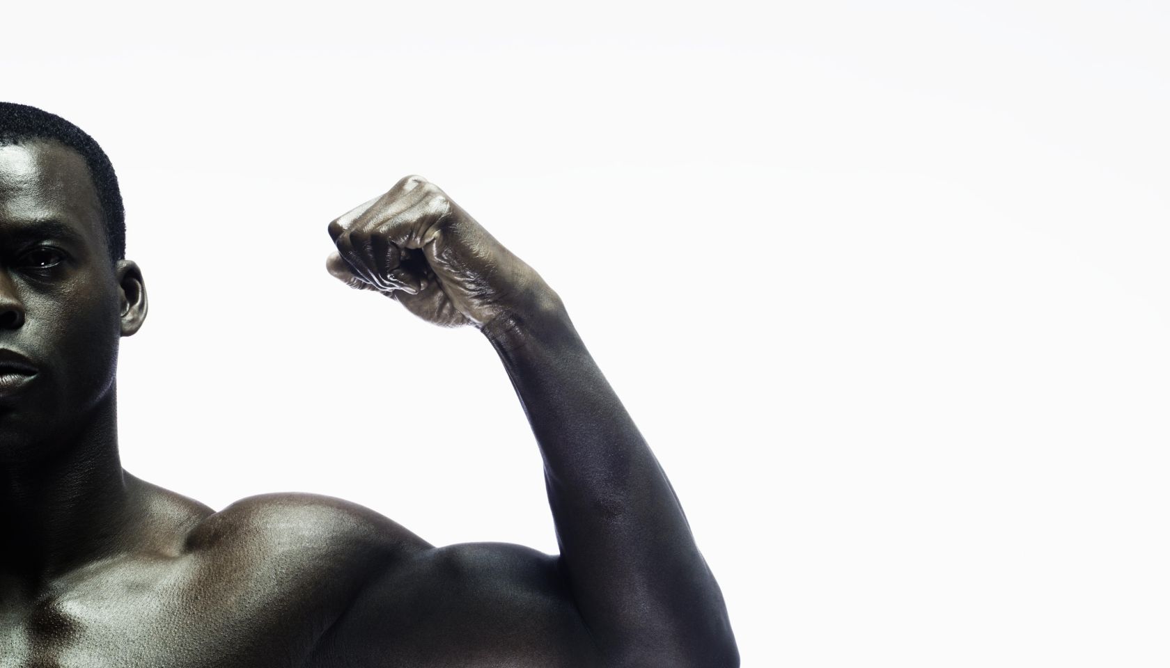 Man showing biceps, portrait, close-up