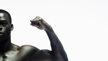 Man showing biceps, portrait, close-up