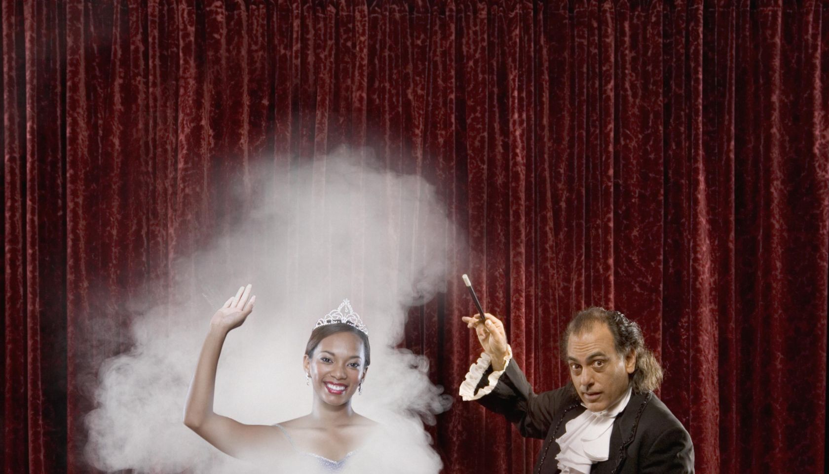 Magician making woman appear out of thin air