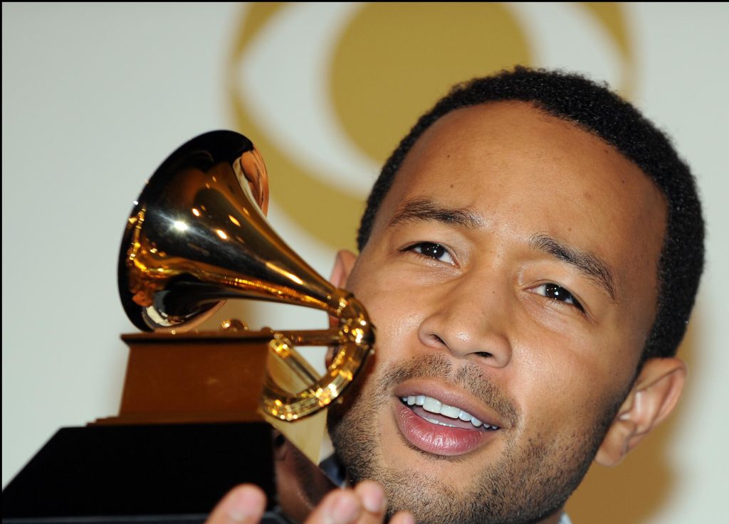John Legend poses with his awards during