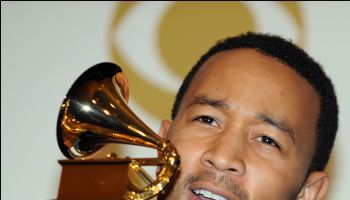 John Legend poses with his awards during
