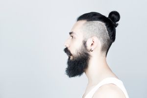 Profile of man with beard and half shaved hair