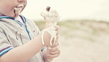 Child eating melted ice cream
