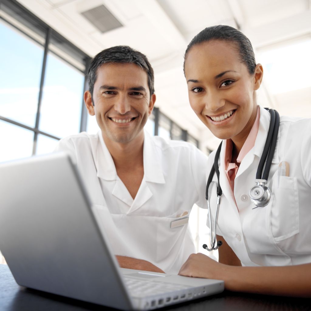 portrait of young medical personnel in front of a laptop