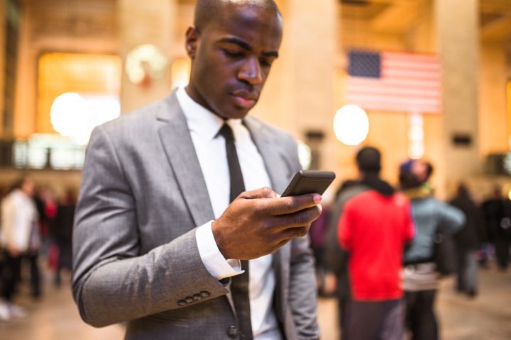 business man portrait in nyc sending sms