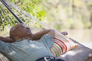 Senior African man laying in hammock