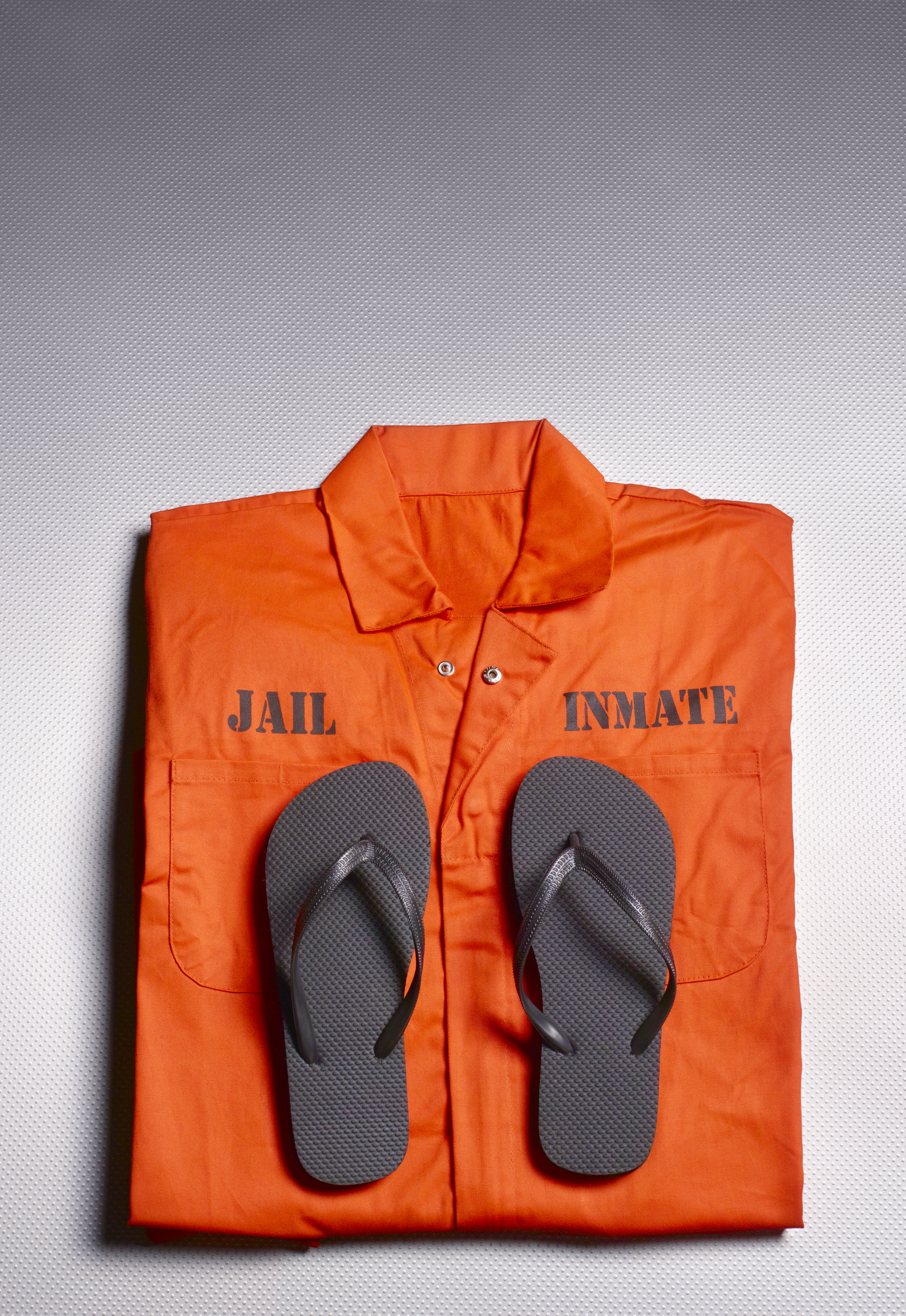 Orange jump suit in prison cell
