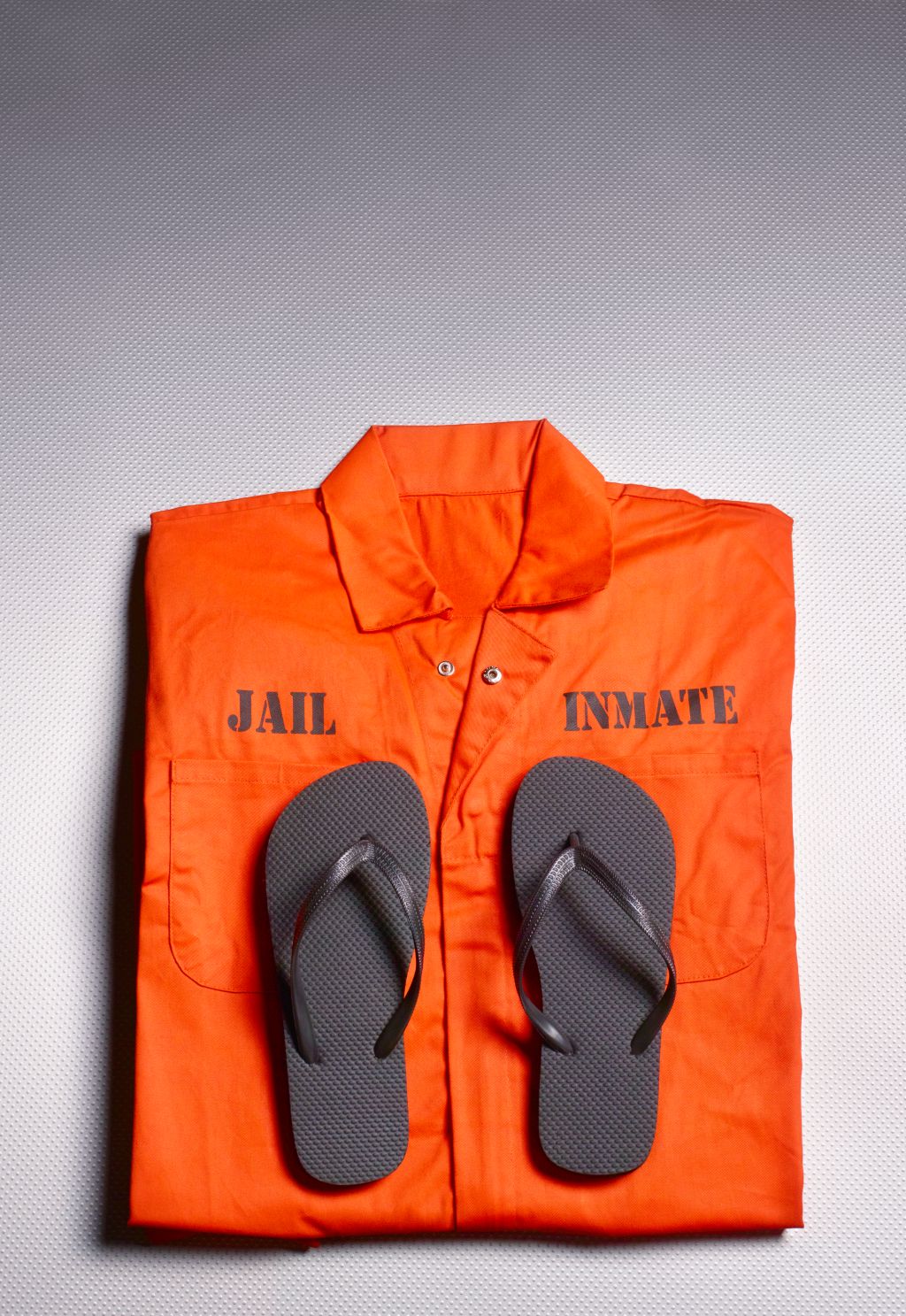 Orange jump suit in prison cell