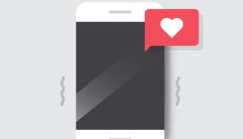 Smartphone with Heart Emoji Speech Bubble Message on Screen.