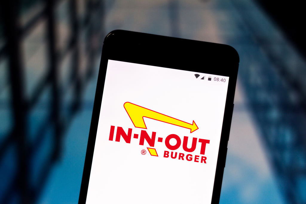 In this photo illustration an In-N-Out Burger logo seen...