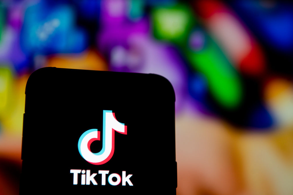In this photo illustration a Tik Tok logo seen displayed on...