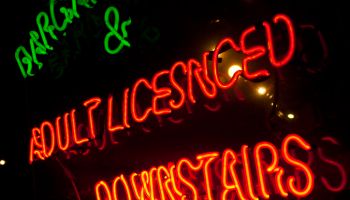 Neon sign offering adult entertainment