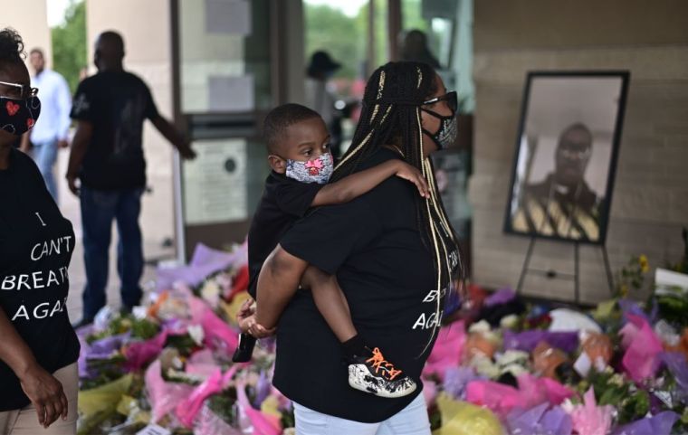 Woman & Daughter Wait To VIew Casket