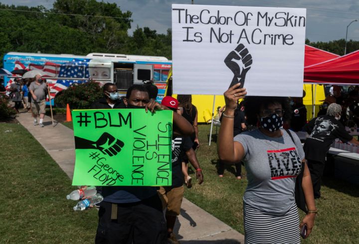 People Holding Black Lives Matter Signs