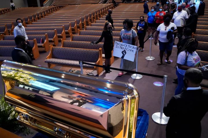 Mourners Pass By The Casket