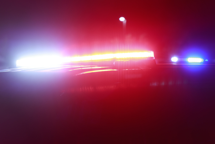 LED police lights illuminated on police car at crime scene