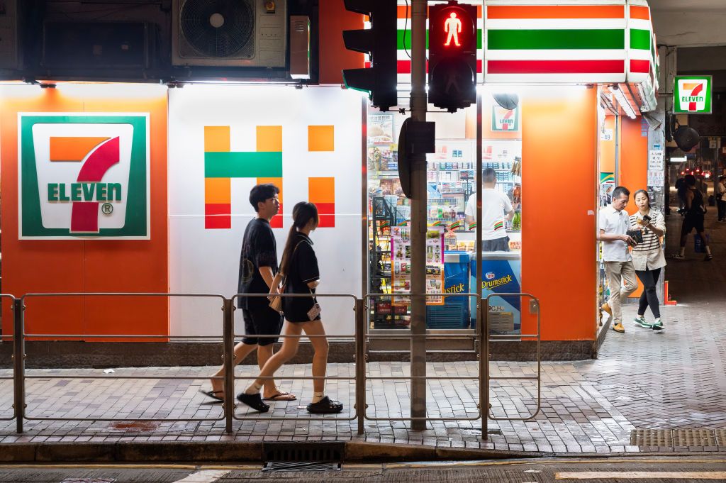 Pedestrians walk past the Japanese-owned American...