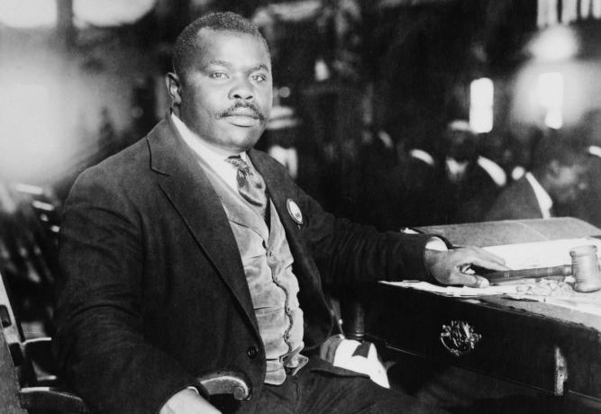 Jamaica: Marcus Garvey (1887-1940), Pan Africanist and Jamaican national hero, seated at his desk, 5 August 1924