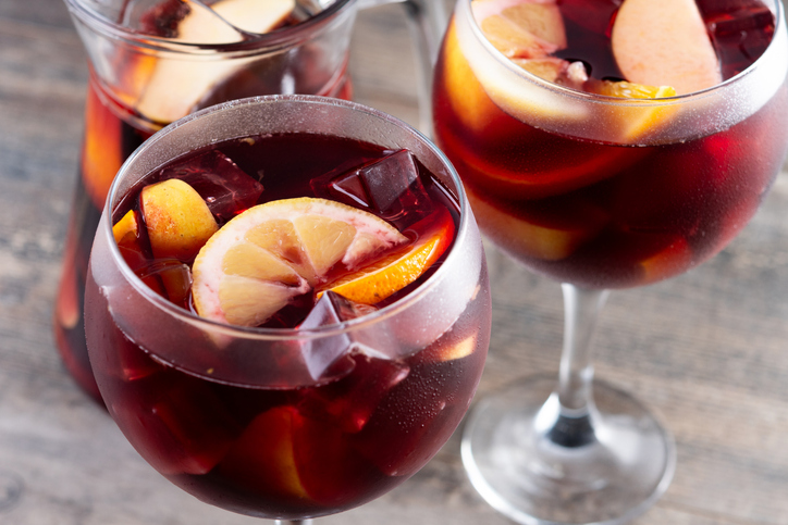Refreshing Summer Citrus Fruit Sangria in crystal jar on wooden table