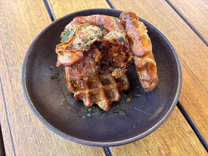 Waffles with fried breaded chicken, bacon and maple syrup