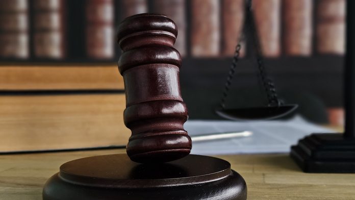 Justice is served with a gavel and scales of justice in a courtroom