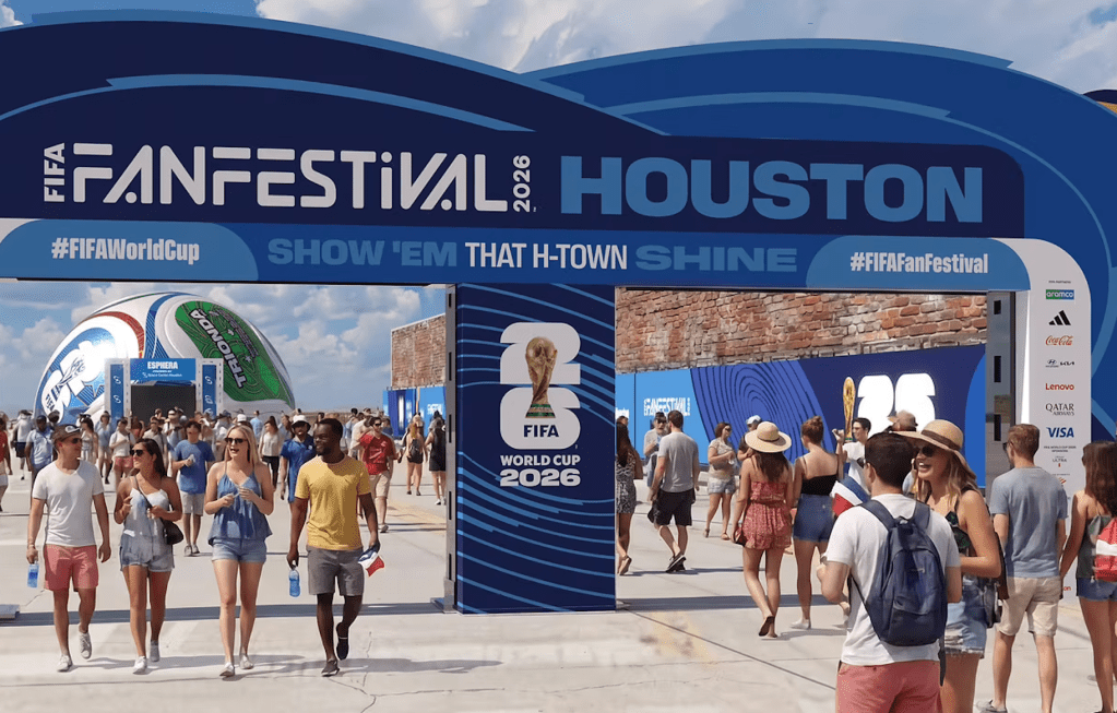 Crowds of people at the FIFA Fan Festival in Houston, with the FIFA World Cup 2026 logo and "Show 'em that H-Town shine" text prominently displayed.