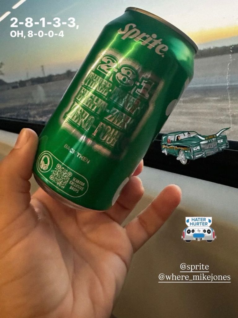 A hand holding a green Sprite soda can with the text "Sprite Zero Sugar" and a vintage car illustration in the background.