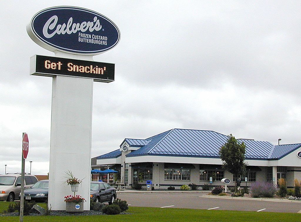 Exterior of a Culver's restaurant with a sign displaying "Get Snackin'". The Culver's logo and branding are prominently displayed.