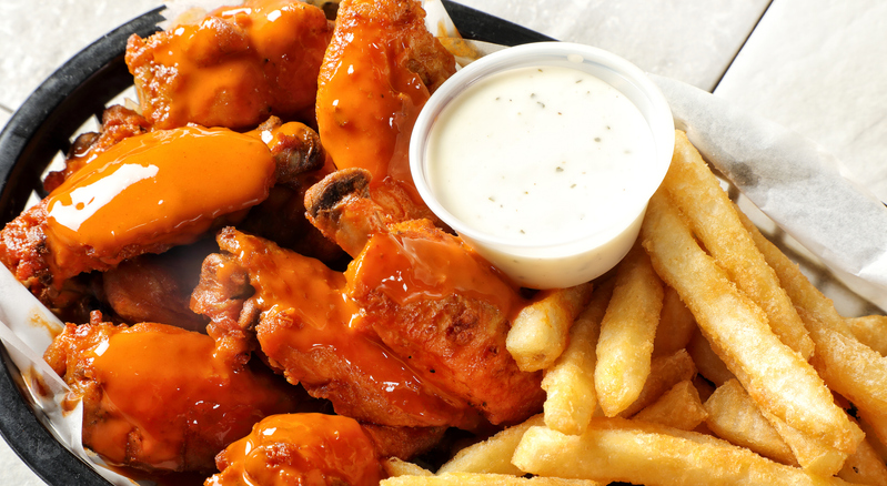 Fried buffalo chicken wings with french fries