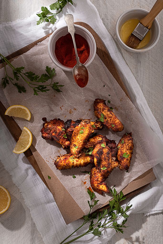 Baked Chicken Wings on a white rustic background