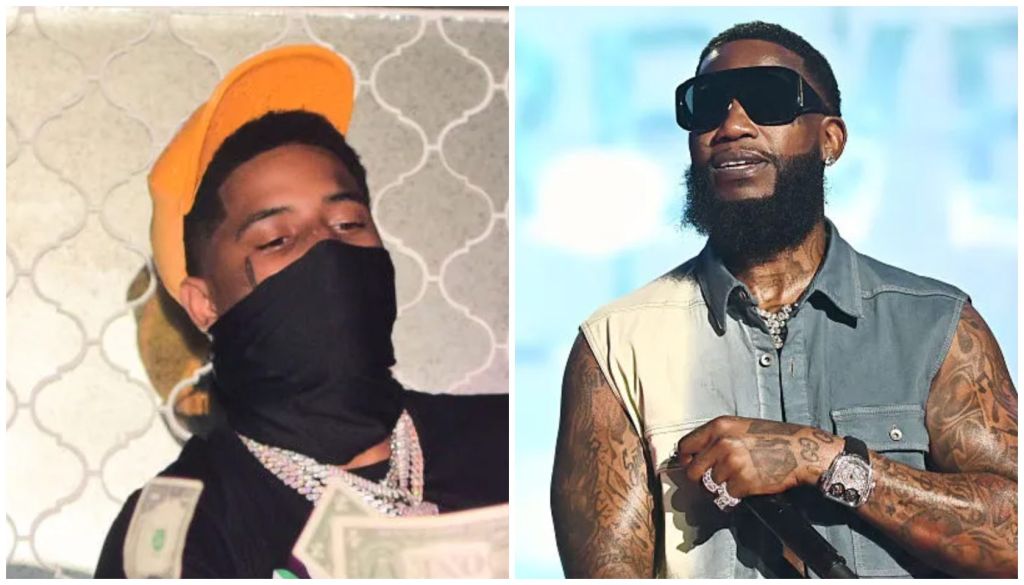 Two men, one wearing a black mask and orange hat, the other with a beard and tattoos wearing sunglasses.