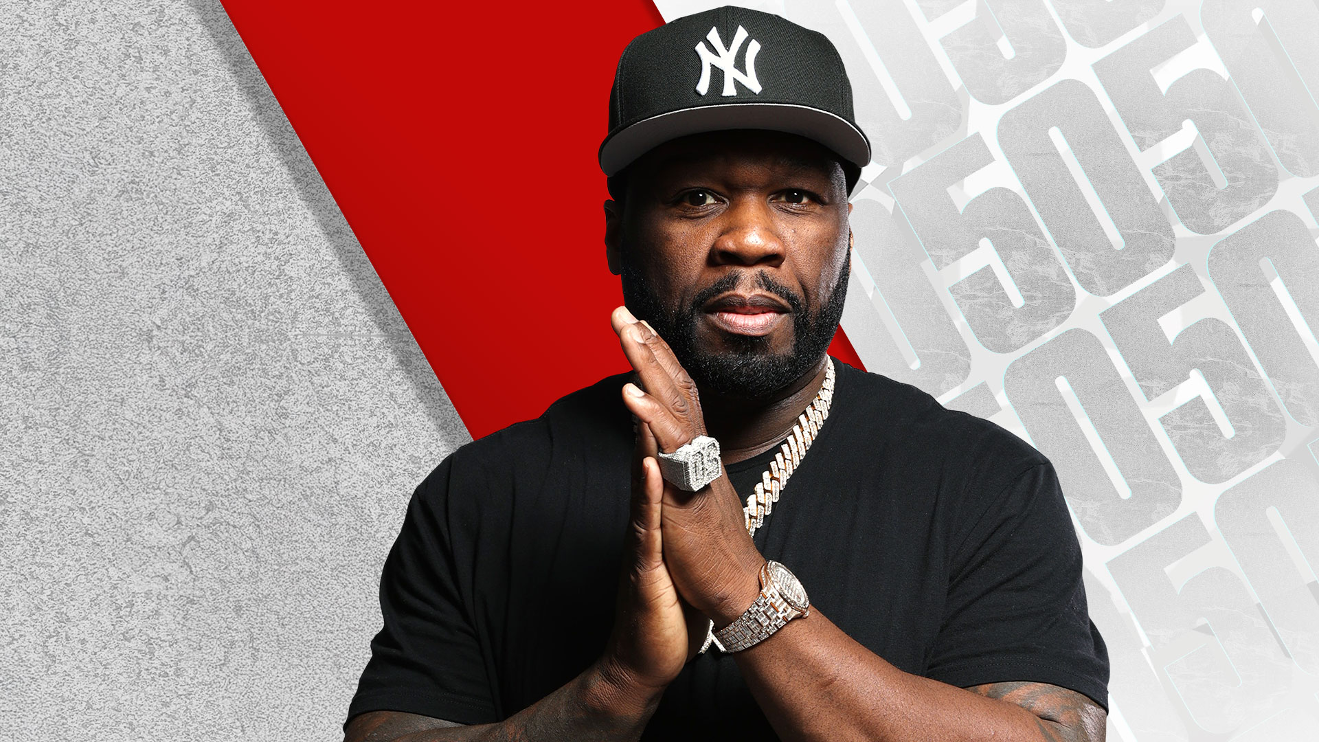A Black man wearing a New York Yankees baseball cap and jewelry, posing with a serious expression against a red and gray background.